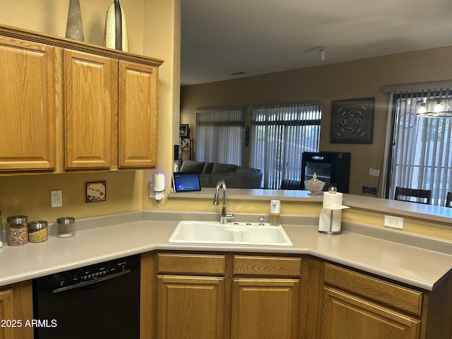 7326 W Dreyfus Dr, Peoria, AZ 85381 - kitchen with black dishwasher, a sink, light countertops, a peninsula, and brown cabinetry
