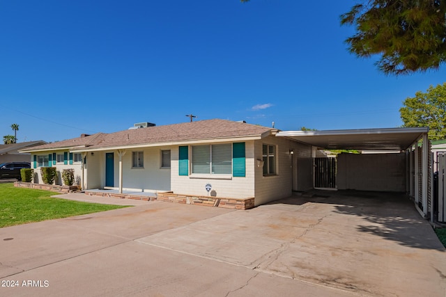 ranch-style home featuring a carport