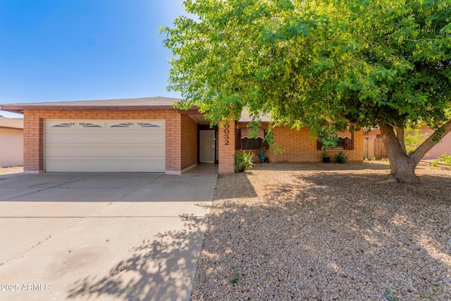 10032 N 50th Dr, Glendale, AZ 85302 - view of front of home featuring a garage, brick siding, and concrete driveway