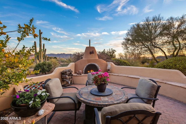 view of patio / terrace featuring a mountain view and an outdoor fireplace