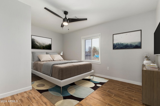 bedroom featuring hardwood / wood-style floors and ceiling fan