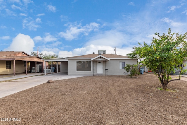 ranch-style home featuring a carport