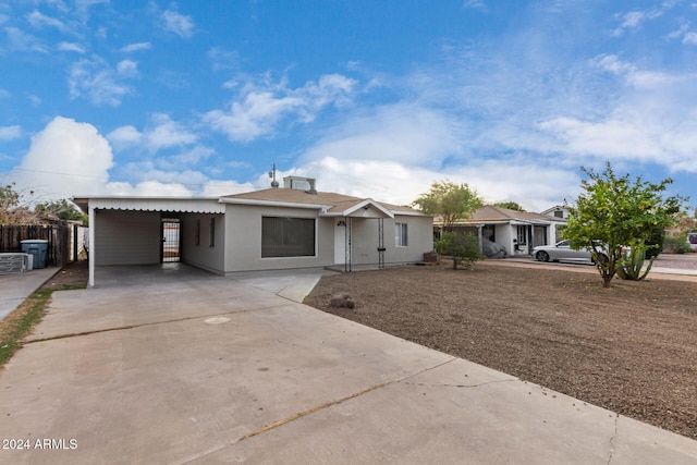 ranch-style house featuring a carport