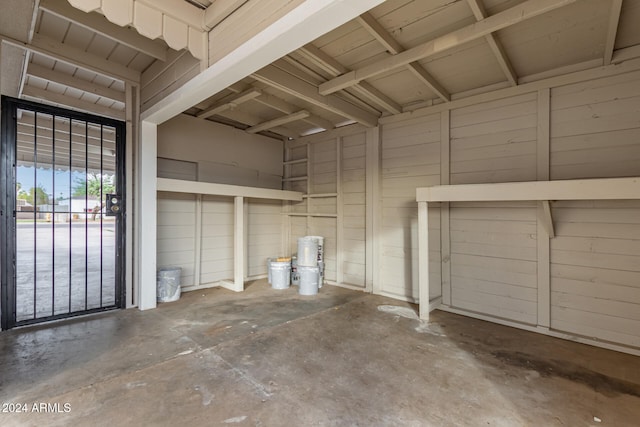 garage featuring wood walls