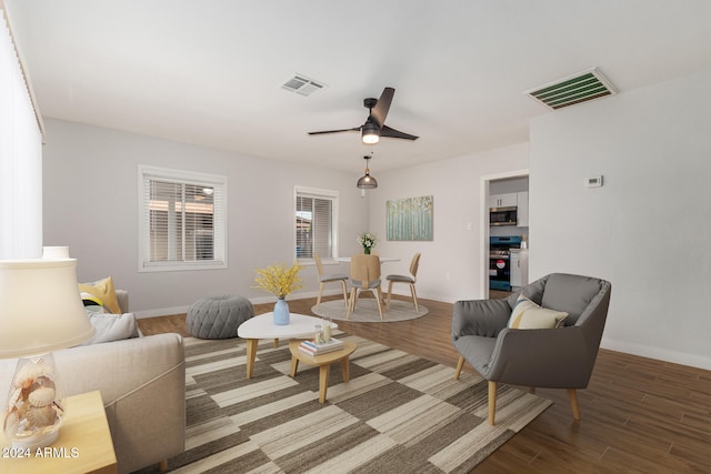 living room featuring hardwood / wood-style floors and ceiling fan