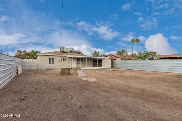 rear view of property featuring a sunroom