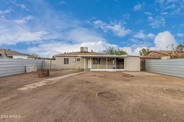 back of property featuring central air condition unit and a sunroom