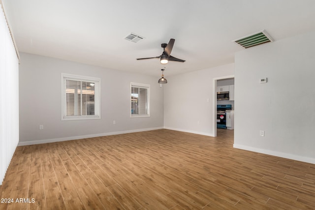 unfurnished room featuring ceiling fan and light hardwood / wood-style floors