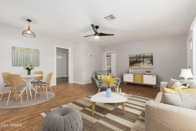 living room featuring ceiling fan and wood-type flooring