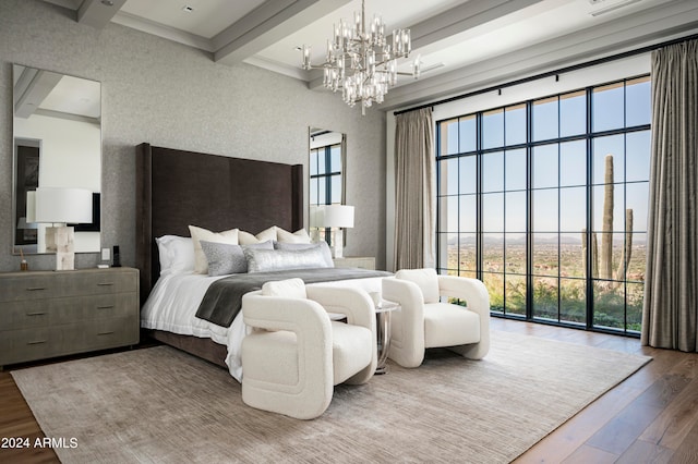 bedroom featuring beam ceiling, a notable chandelier, crown molding, and hardwood / wood-style floors