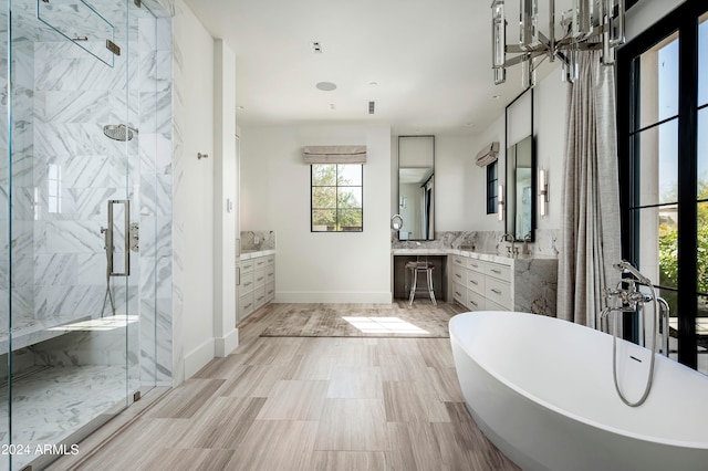 bathroom featuring vanity and shower with separate bathtub