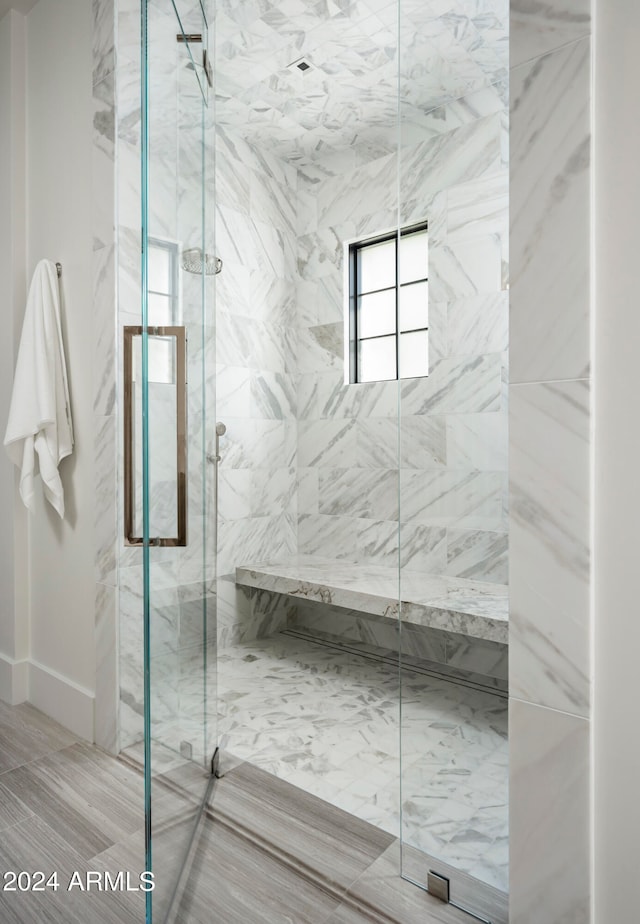 bathroom featuring a shower with shower door