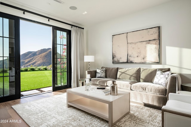 living room featuring a mountain view and light hardwood / wood-style flooring