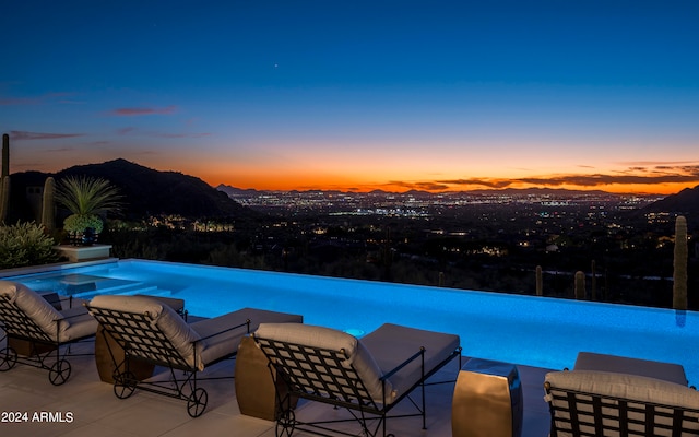 pool at dusk with a mountain view