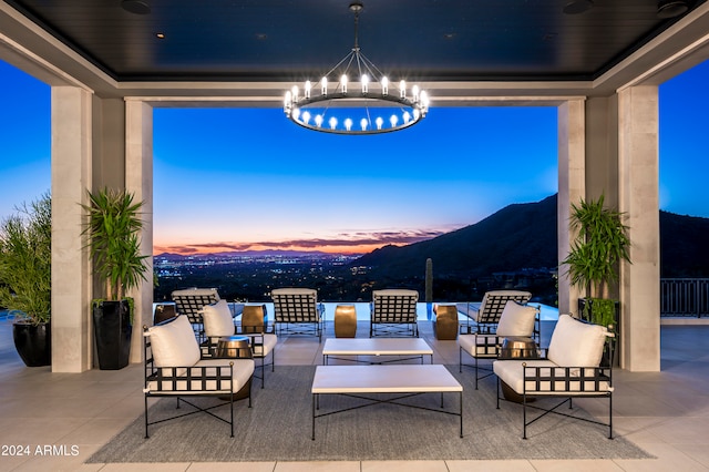 patio terrace at dusk with a mountain view and an outdoor living space