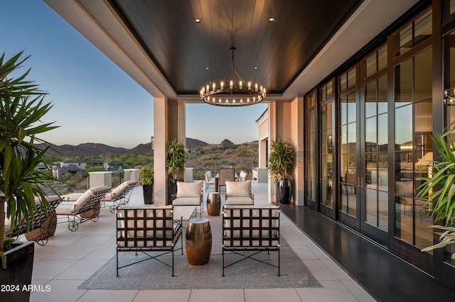 patio terrace at dusk featuring outdoor lounge area and a mountain view