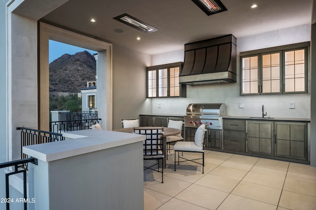 kitchen with a mountain view, sink, plenty of natural light, and custom exhaust hood