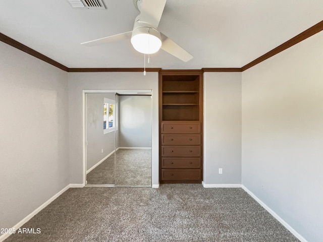 unfurnished bedroom featuring baseboards, ceiling fan, crown molding, carpet flooring, and a closet