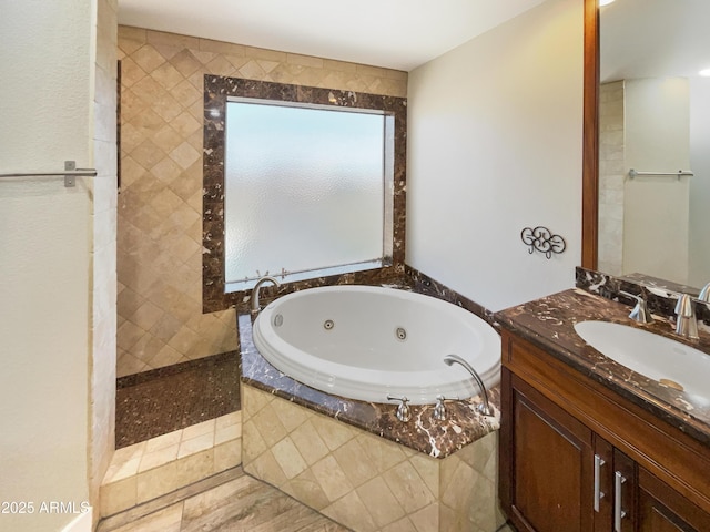 bathroom featuring a jetted tub and vanity