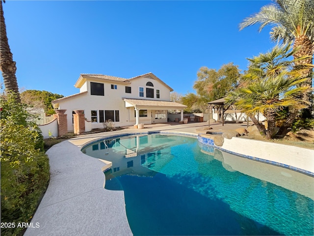 pool with a gazebo, fence, and a patio