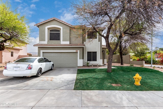 1635 W Dunbar Dr, Phoenix, AZ 85041 - mediterranean / spanish-style home with a tile roof, stucco siding, concrete driveway, fence, and a garage
