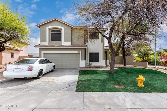 mediterranean / spanish-style home with a tile roof, stucco siding, concrete driveway, fence, and a garage