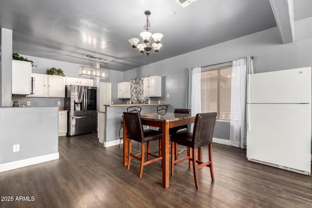 dining room with dark wood-style floors, baseboards, and a chandelier