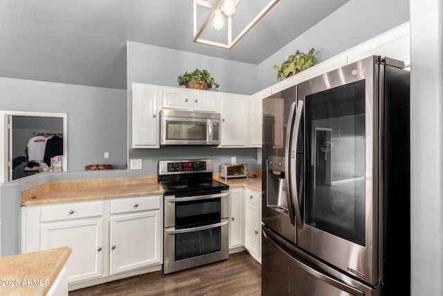 kitchen featuring stainless steel appliances, light countertops, dark wood-style flooring, and white cabinetry