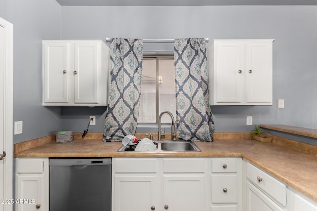 kitchen featuring light countertops, stainless steel dishwasher, a sink, and white cabinetry