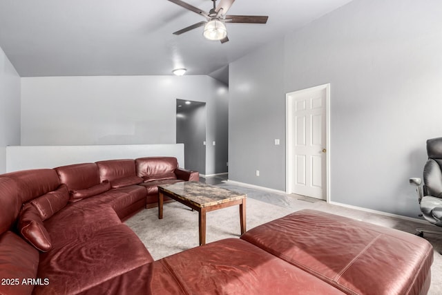 living room with light carpet, vaulted ceiling, a ceiling fan, and baseboards