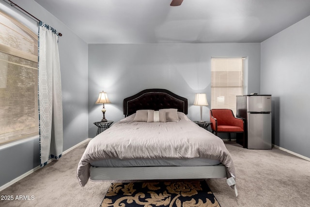 bedroom featuring carpet floors, a ceiling fan, freestanding refrigerator, and baseboards