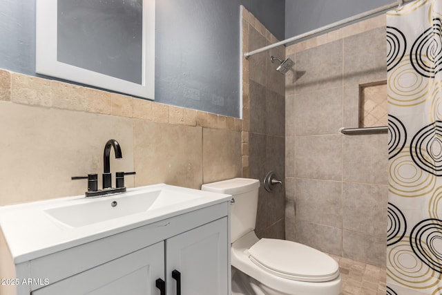 full bath with tile walls, a tile shower, vanity, and toilet