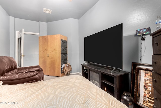 bedroom with visible vents and baseboards