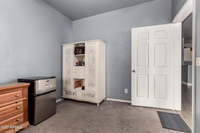 interior space featuring carpet and baseboards