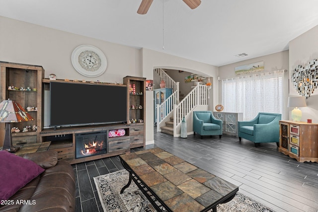 living room with ceiling fan and dark hardwood / wood-style flooring