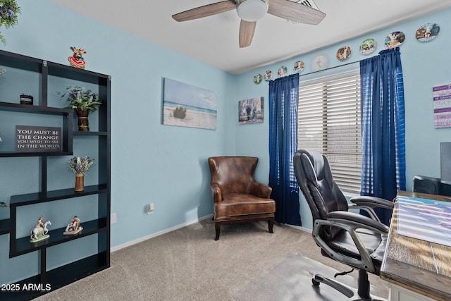 carpeted home office featuring ceiling fan