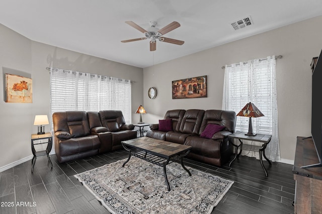 living room featuring plenty of natural light and ceiling fan