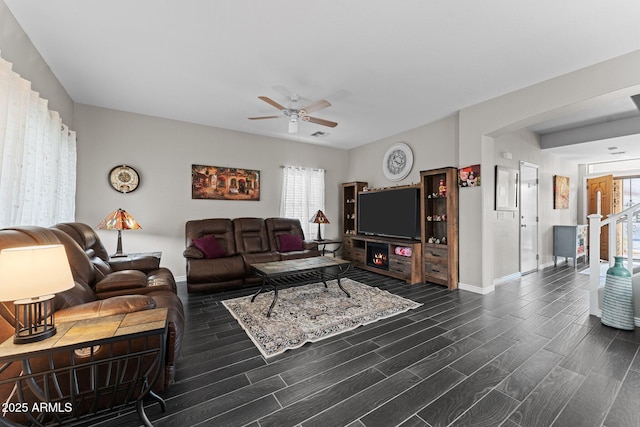 living room with dark wood-type flooring and ceiling fan