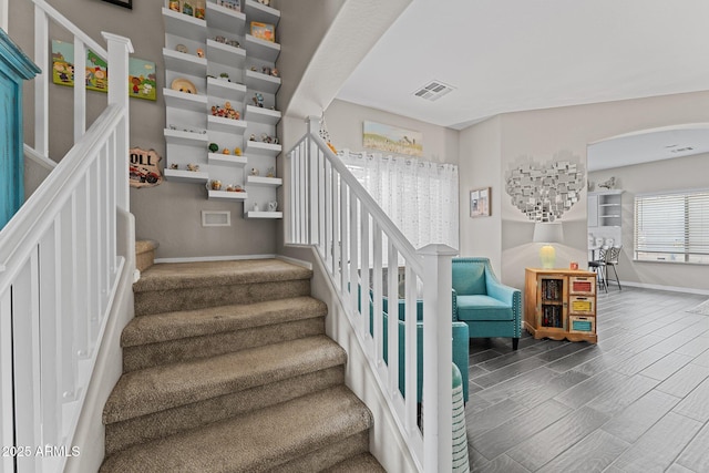 staircase with hardwood / wood-style floors