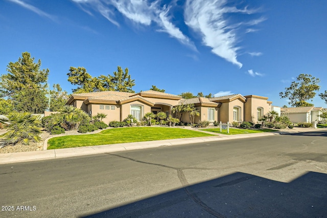 mediterranean / spanish house with a front yard