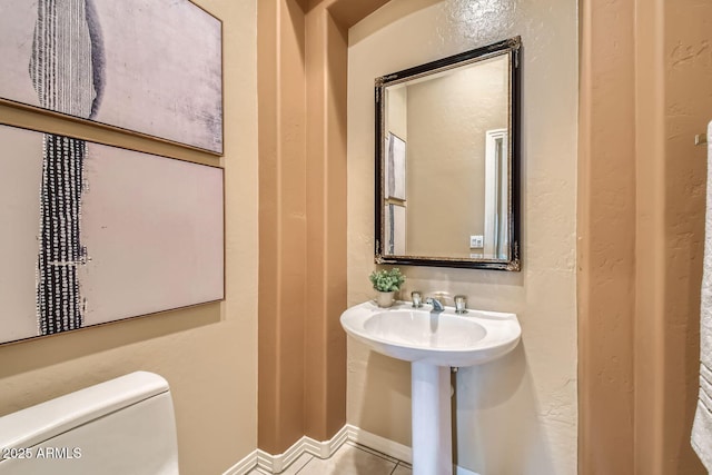 bathroom with tile patterned floors and toilet