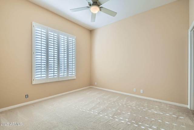 empty room featuring ceiling fan and light colored carpet