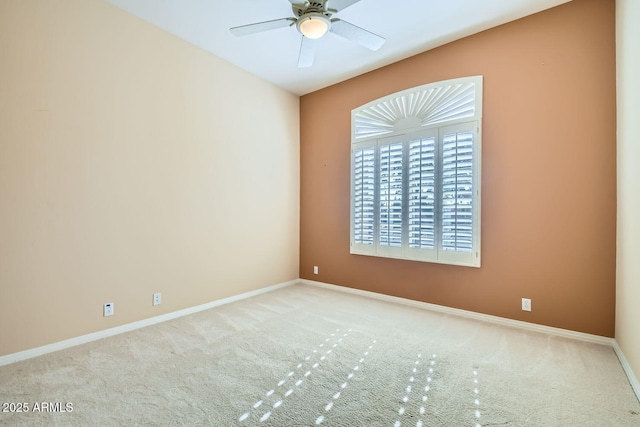 carpeted empty room featuring ceiling fan