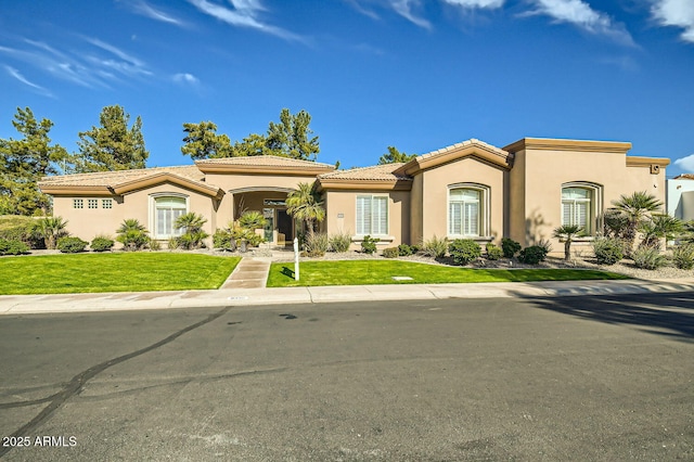 mediterranean / spanish-style house with a front yard