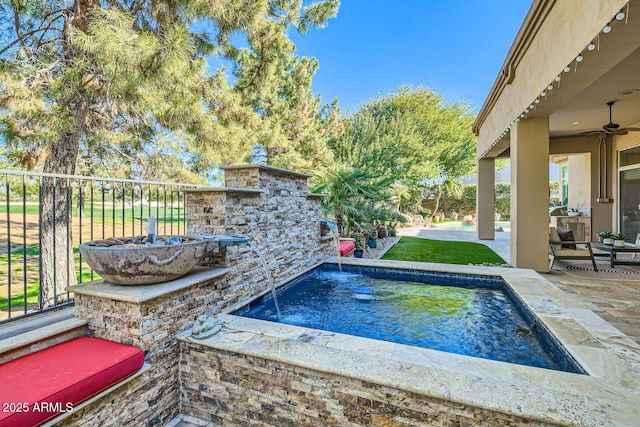 view of swimming pool featuring ceiling fan and a patio area