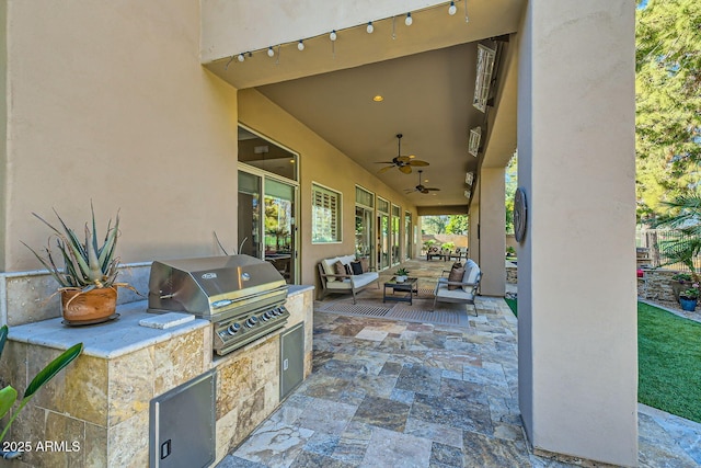 view of patio / terrace with ceiling fan, an outdoor kitchen, an outdoor hangout area, and area for grilling