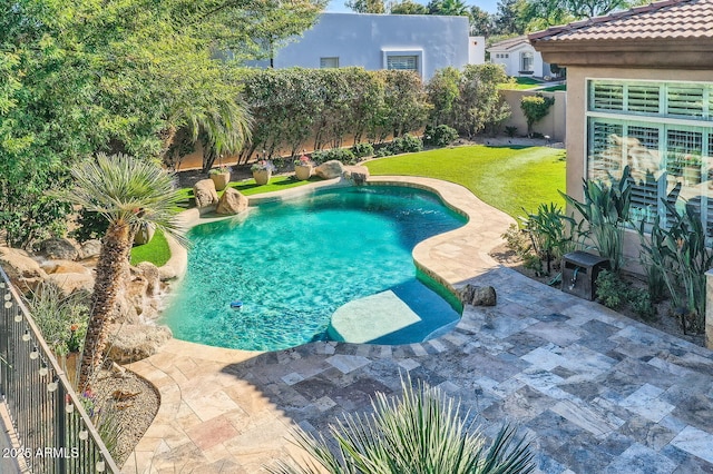 view of swimming pool featuring a lawn and a patio