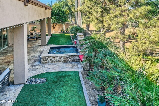 view of yard with an in ground hot tub and a patio