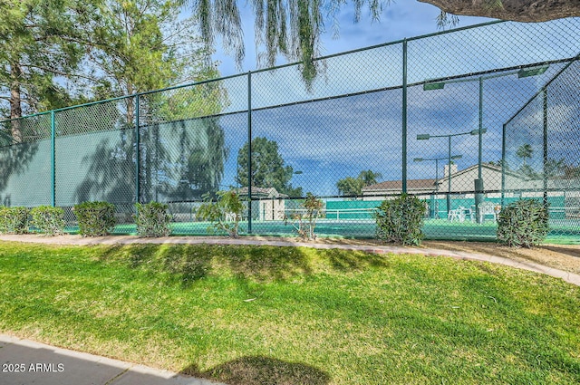 view of sport court featuring a yard