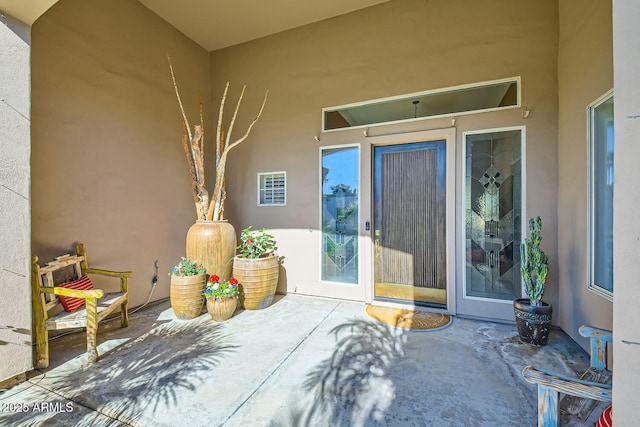 entrance to property featuring a patio